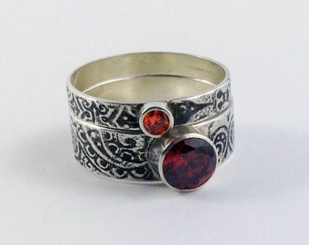 The Autumn Stack ring set in garnet and topaz coloured stones and paisley patterned band