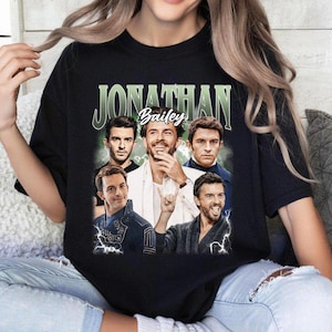 May include: Black t-shirt with a graphic print of five men. The text "Jonathan Bailey" is printed on the shirt.