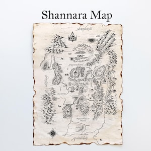 Puede incluir: Un mapa detallado de Shannara, con intrincadas ilustraciones de montañas, bosques y cuerpos de agua. El mapa está impreso en papel envejecido con un borde quemado, y el título "Shannara Map" se muestra en la parte superior.
