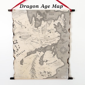May include: A wall scroll featuring a map of the Dragon Age world, printed on aged paper with burnt, uneven edges. The map displays regions like Orlais, Ferelden, and the Tevinter Imperium, suspended by a red ribbon and dark wooden rods.