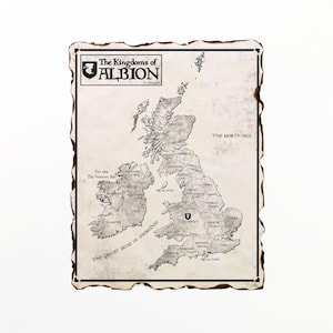 May include: A vintage-style map of the British Isles, labeled "The Kingdoms of Albion." The map is in grayscale with detailed geographical features and place names. The edges of the paper have a burnt, aged appearance, giving it a historical feel.