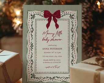 May include: A rectangular baby shower invitation card featuring a dark red bow at the top, green and white striped borders, and a decorative frame with holly illustrations. The text reads Merry little baby shower, celebrating ANNA PETERSON, december 20th at 6 pm, 123 any street, city, state, Kindly RSVP by 12/15 to Emma at 123456789, registered at Target.