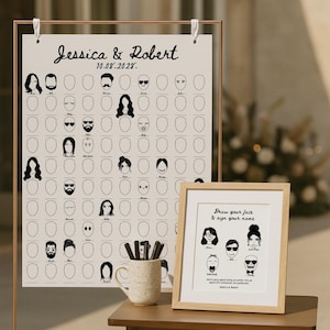 May include: A wedding guest book alternative featuring a large poster with illustrated faces and a framed print. The poster is labeled "Jessica & Robert 10.08.2028" and includes space for guests to draw their faces. A mug with pens is on the table.