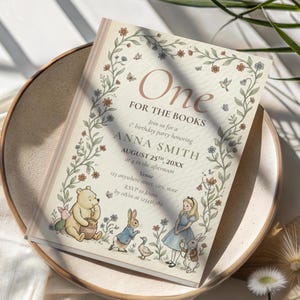 May include: A charming invitation for a first birthday celebration, with the words "One FOR THE BOOKS" at the top. The design incorporates illustrations of beloved storybook characters like Winnie the Pooh and Alice in Wonderland, framed by floral and butterfly motifs.