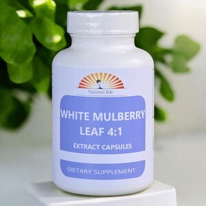 May include: A white bottle of dietary supplement capsules. The label reads "White Mulberry Leaf 4:1 Extract Capsules" with the brand name "Natures Isle" above. The bottle is on a white surface with green foliage in the background.