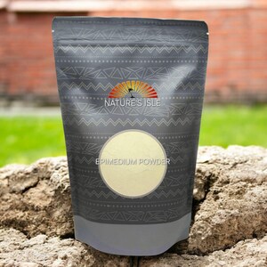 May include: A dark gray pouch with a geometric pattern and the text "NATURE'S ISLE" and "EPIMEDIUM POWDER". The pouch contains a light beige powder visible through a circular window. The background features a brick wall and greenery.