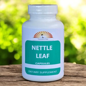 May include: A white plastic bottle of Nettle Leaf capsules. The label features a teal green rectangle with the words "Nettle Leaf Capsules" in white. The bottle has a white cap and a logo of a palm tree with a sunburst.