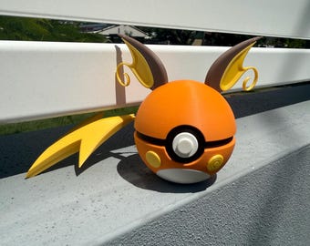 May include: A 3D printed orange and yellow Pokemon figure of a Jolteon. The figure is in the shape of a Pokeball with a yellow tail and brown ears.