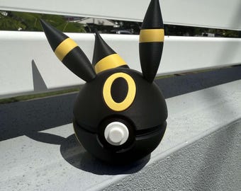 May include: A black and yellow 3D printed Pokemon figurine of a dark-type Pokemon,  known as  "Darkrai".