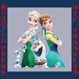 May include: A DTF (Direct to Film) transfer featuring Elsa, Anna, and Olaf from the movie Frozen. Elsa is in a green dress, Anna in a blue dress, and Olaf has a carrot nose. The words "READY TO PRESS" and "DTF TRANSFER" are printed on the sides.