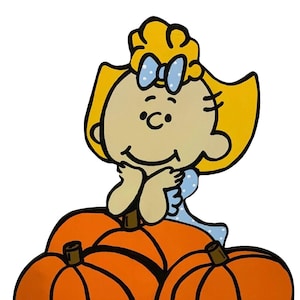 Può includere: Illustrazione di un cartone animato di una ragazza con i capelli biondi e un fiocco blu, appoggiata a un gruppo di zucche arancioni. La ragazza indossa un vestito blu a pois bianchi. Le zucche hanno steli marroni e contorni neri.