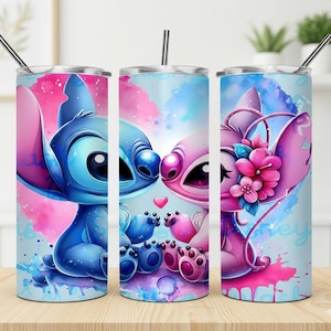 May include: Three stainless steel tumblers with cartoon character designs. The tumblers feature a blue and pink alien couple with a watercolour background. Each tumbler has a silver straw.