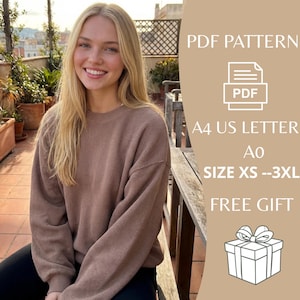 May include: A woman wearing a brown waffle-knit sweater. The image includes text that reads "PDF PATTERN", "A4 US LETTER", "SIZE XS --3XL", and "FREE GIFT". A gift box graphic is also present.