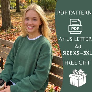 May include: A woman wearing a green sweatshirt with a white collar sits on a wooden bench in a park. The image includes text that says "PDF PATTERN", "A4 US LETTER", "SIZE XS --3XL", and "FREE GIFT".
