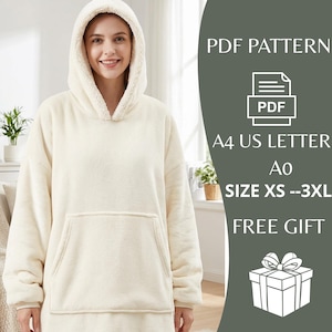 May include: Cream-colored oversized hoodie with a large front pocket and a cozy, sherpa-lined hood. The hoodie is a soft, plush material, perfect for lounging. The image also includes text that says "PDF Pattern", "A4 US Letter", "Ao", "Size XS - 3XL", and "Free Gift".
