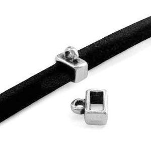 May include: Two silver-toned metal cord end caps for leather cord. The caps have a rectangular shape with a small loop at the top. One cap is shown threaded onto a black leather cord.