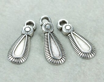 May include: Three silver teardrop-shaped pendant charms with a decorative design. Each charm has a small circle with a raised design at the top.