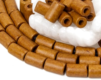 May include: A strand of brown wooden beads, with a pile of loose brown wooden beads in the background.