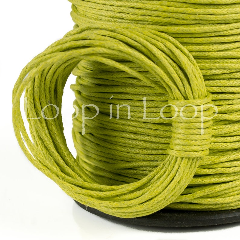 May include: A spool of lime green cord wrapped in a tight, continuous coil. The cord features a textured, fibrous surface and is wound around a central core. The text "Loop in Loop" is overlaid in white across the center of the lime green cord.