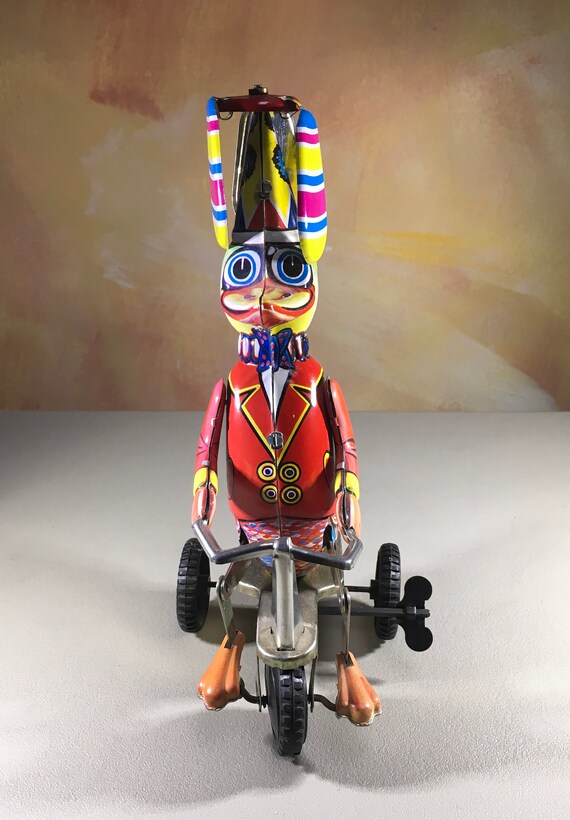 Collectibles Tin wind up toy duck on a bicycle with twirling helicopter