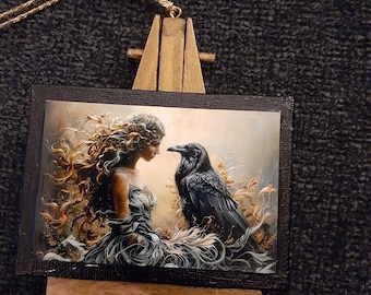 Celtic Goddess Morrigan and Raven ornament on an easel.