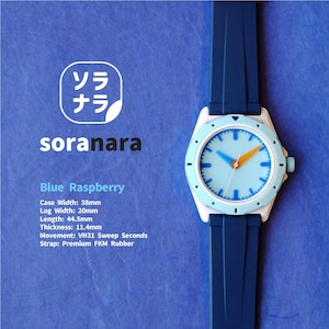 May include: A blue and white wristwatch with a blue rubber strap. The watch face is light blue with white markings and orange and blue hands. The watch is labeled "soranara" and "Blue Raspberry". The watch has the following specifications: Case Width: 38mm, Lug Width: 20mm, Length: 44.5mm, Thickness: 11.4mm, Movement: VH31 Sweep Seconds, Strap: Premium FKM Rubber.