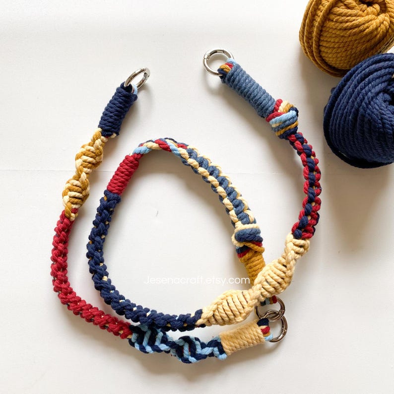 May include: Two macrame bag handles in red, navy, and tan colors with silver metal rings. The handles are made of braided and knotted rope. Two balls of yarn in mustard yellow and navy blue are in the background. The website address Jesenacraftetsy.com is visible.