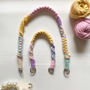 May include: Two macrame bag handles in pastel shades, with metal rings. The handles are in shades of yellow, pink, purple, and blue. Two balls of yarn in yellow and pink are in the background. The Etsy shop name "Jesenacraft.etsy.com" is visible.