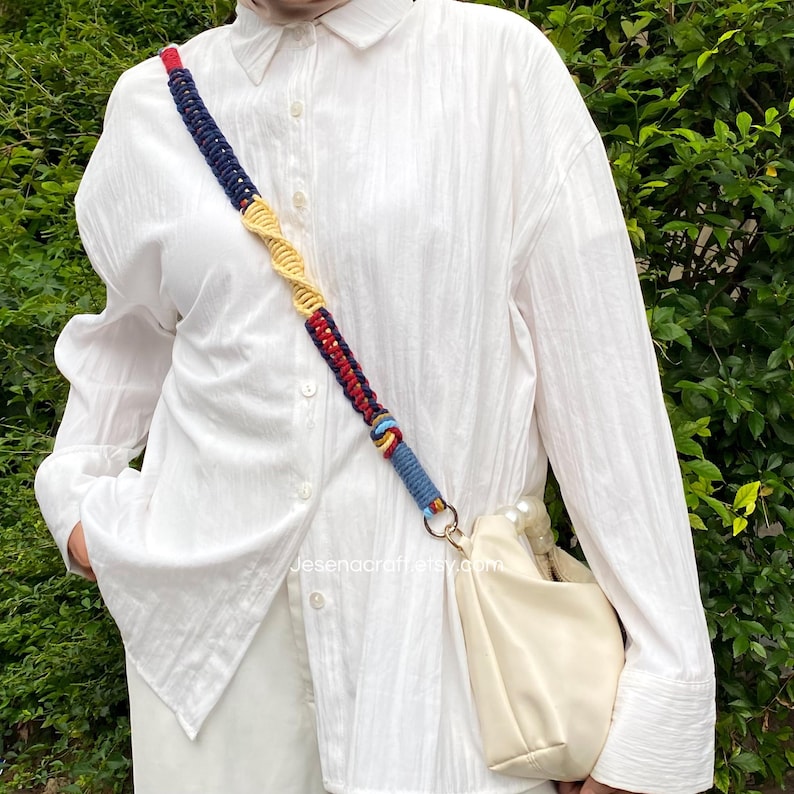 May include: A cream-colored handbag with a colorful macrame strap. The strap features blue, red, and yellow woven sections. The bag is worn over the shoulder. The website address Jesenacraft.etsy.com is visible on the image.