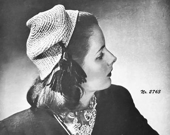 May include: A black and white photo of a woman wearing a white crocheted hat with a black feather trim. The hat is styled with a pointed crown and a wide brim. The woman is wearing a black jacket and white gloves. The photo includes the text "No. 2763".