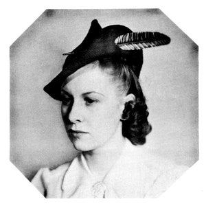 May include: A black and white photo of a woman wearing a black hat with a feather. The hat is tilted at an angle and the feather is pointing to the right. The woman has short, curly hair and is looking down.