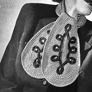 May include: A black and white photo of a woman wearing a crocheted scarf with a leaf design and black beads. The scarf is tied around her neck and the ends are hanging down. The woman is wearing a dark jacket. The photo is labeled "No. 2773".