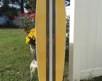 Surfboard wall art. Distressed yellow surf decor.