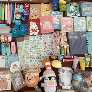 May include: A collection of stationery and small toys, including pens, notebooks, stickers, lip balms, and plushies. The items feature various cartoon characters and designs in a variety of colors, including pink, blue, yellow, and green.