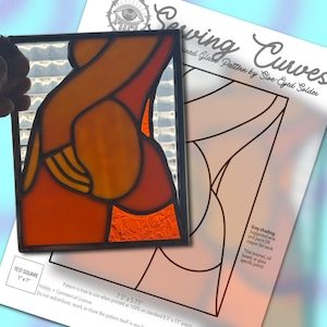 May include: A stained glass piece featuring abstract orange and red curves with a textured clear glass background, displayed over a printed paper pattern titled Sewing Curves by Sloe-Eyed Solder, which includes a 1 inch by 1 inch test square.