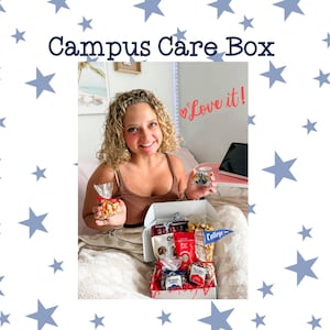 May include: A woman holding a Campus Care Box filled with snacks and treats. The box contains various packaged snacks, popcorn, and a pennant. She also holds a small bag of candy corn and a jar of treats. The words "Campus Care Box" are at the top.