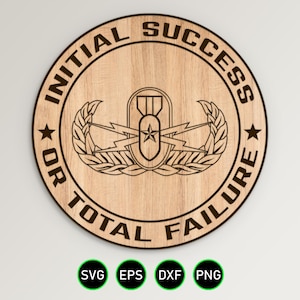 May include: A wooden round sign with the text "Initial Success or Total Failure" and a military insignia in the center. The sign is brown with black text.