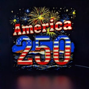 May include: A patriotic design featuring the word "America" in red and white, with the number "250" in red, white, and blue. Fireworks burst in the background against a dark blue backdrop, celebrating a national holiday.