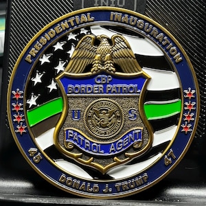May include: A gold-colored coin with a blue, white, and black American flag design. The center of the coin features a shield with the words "CBP Border Patrol" and "Patrol Agent". The coin also has the text "Presidential Inauguration 45 Donald J. Trump 47".