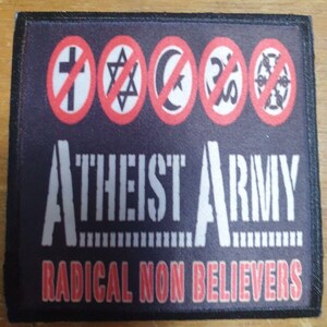 May include: Black patch with red and white symbols of a cross, Star of David, crescent moon, and Om symbol, all with a red circle and diagonal line through them. The text "Atheist Army" in white and "Radical Non Believers" in red.