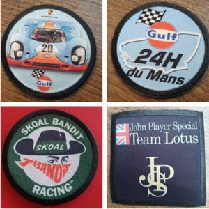 May include: Four embroidered patches. The first patch is blue and white with a red and orange race car. The second patch is blue and white with a red circle that says "Gulf" and a white track with the text "24H du Mans". The third patch is green with a white cartoon bandit wearing a hat and the text "SKOAL BANDIT RACING". The fourth patch is black with a white Union Jack flag, the text "John Player Special Team Lotus", and a gold "JP" logo.