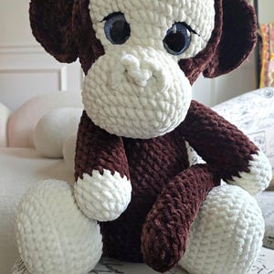 May include: A white ceramic mug with a black handle and the text "But First, Coffee" in a black, handwritten-style font. The mug is on a white surface.