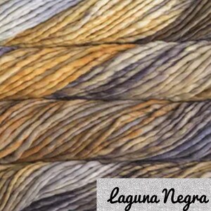 May include: Close-up of a skein of yarn with a variegated colour pattern of brown, beige, and grey. The yarn is textured and has a soft, fuzzy appearance. The text "Laguna Negra" is visible in the lower right corner of the image.