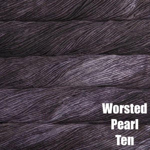 May include: Close-up of a dark grey yarn skein. The yarn is a worsted weight and is called "Pearl Ten".