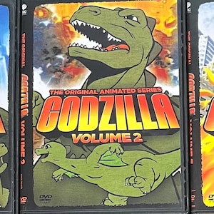 May include: Three DVD cases for the Godzilla The Original Animated Series, labeled Volume 1, Volume 2, and Volume 3. Each cover features a green Godzilla character, city backgrounds, and illustrations of human characters on the first volume.