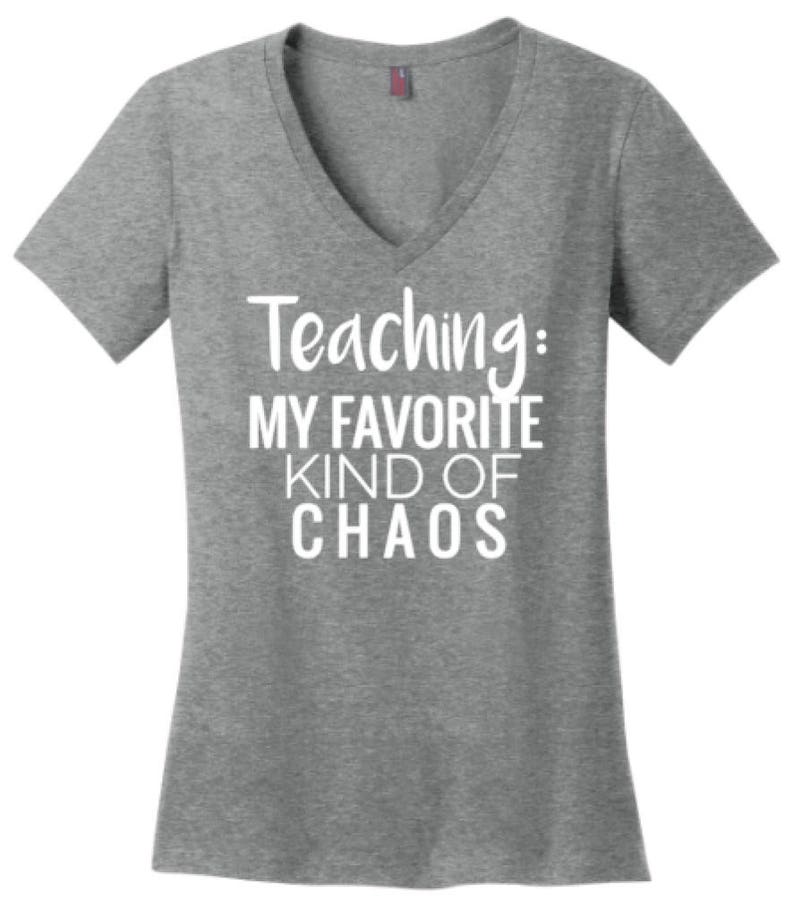 May include: Gray V-neck t-shirt with the text "Teaching: My Favorite Kind of Chaos" in white.