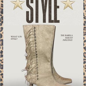May include: Beige suede heeled boots with fringe detail and a row of silver studs up the back of the boot. The boots are styled with a pointed toe and a low heel. The text "The Isabella Marant Influence" is printed on the right side of the image.