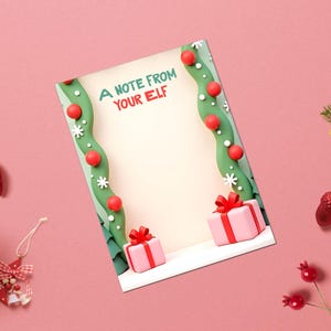May include: A Christmas-themed greeting card with the text "A NOTE FROM YOUR ELF" on a pink background. The card is decorated with red ornaments, green garland, and pink gift boxes. Festive decorations surround the card.