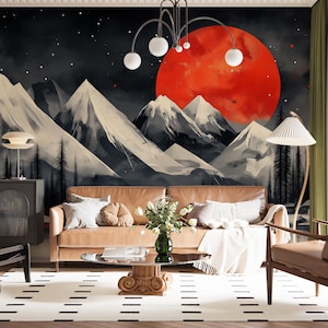 May include: A living room with a tan leather sofa, glass coffee table, and patterned rug. The wall features a mural of mountains under a red sun. A modern lamp and chandelier provide lighting. The room has a contemporary design with a nature-inspired theme.