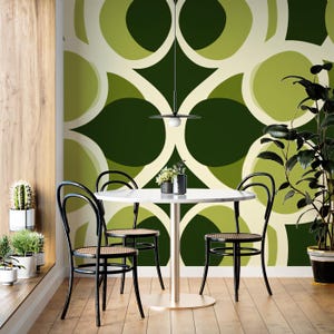 May include: A dining room set with a white marble-topped table and four black chairs with woven seats. The chairs are arranged around the table. The background features a green and cream geometric wallpaper. A hanging light fixture is above the table.